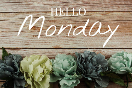 Hello Monday typography text with blue flowers bouquet on wooden background