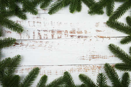 Christmas background with fir tree branches border frame on wooden backgroundの写真素材