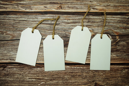 Flat lay White Blank Tag on wooden backgroundの写真素材