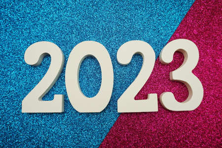 2023 Happy New Year with space copy on blue and pink glitter backgroundの写真素材