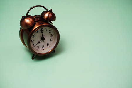 Vintage alarm clock with space copy on green backgroundの写真素材