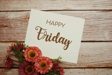 Happy Friday card typography text with flower bouquet on wooden backgroundの写真素材