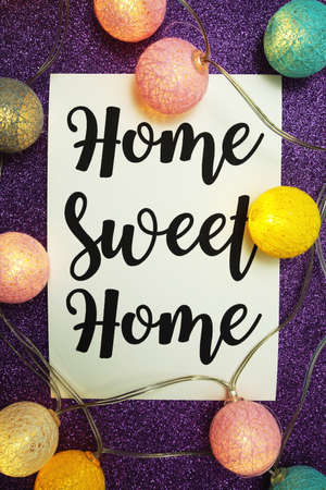 Home Sweet Home typography text with peony flowers on blue backgroundの写真素材