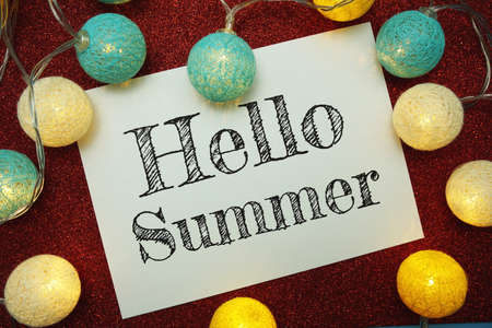 Hello Summer typography text with LED cotton ball on red glitter backgroundの写真素材