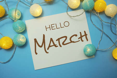 Hello March typography text with LED cotton ball on blue backgroundの写真素材