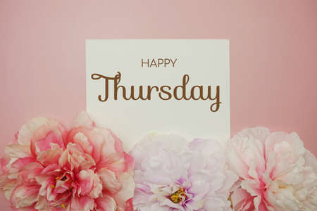 Happy Thursday typography text with flower decor on pink backgroundの写真素材