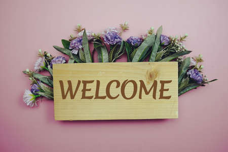 Welcome Sign with flowers frame decprate on pink backgroundの写真素材