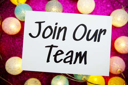 Join Our Team text on paper card top view on pink bokeh backgroundの写真素材
