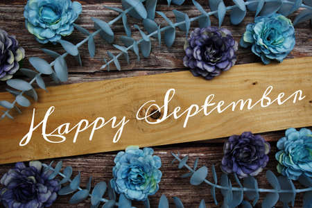 Happy September alphabet letter and flower decorate on wooden backgroundの写真素材