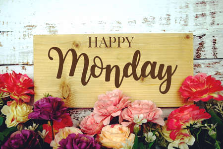 Happy Monday text on wooden planks decoration with flower border frameの写真素材