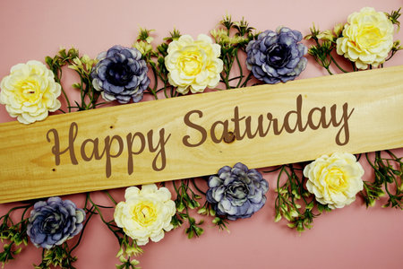 Happy Saturday typography text and flower decorate on pink backgroundの写真素材
