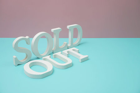 Sold Out alphabet letter on blue and pink background