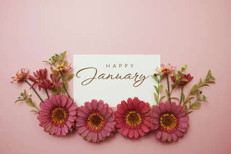 Happy January typography text with flowers on pink backgroundの写真素材