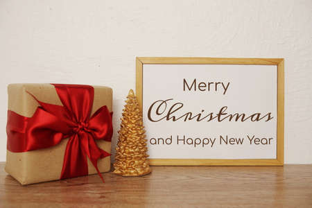 Merry Christmas and Happy New Year text with giftbox and Christmas tree decorateの写真素材