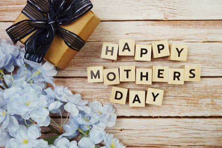 Happy Valentines day alphabet letter with gift present and flower decoration on wooden backgroundの写真素材