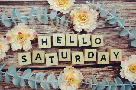 Hello Saturday alphabet letter and flower decorate on wooden backgroundの写真素材