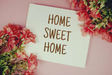 Home Sweet Home typography text with flowers on pink backgroundの写真素材