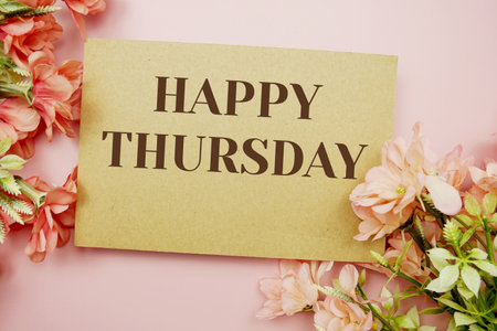 Happy Thursday typography text with flowers on pink backgroundの写真素材