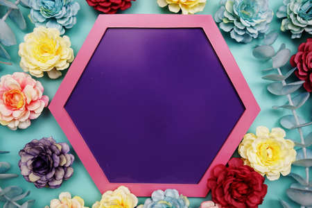 Purple Hexagon background and pink border decorate with flowers on blue backgroundの写真素材