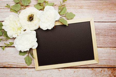 Empty Blackboard with flower decorate on wooden background