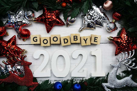 Goodbye 2021 alphabet letters and christmas decoration on wooden backgroundの写真素材