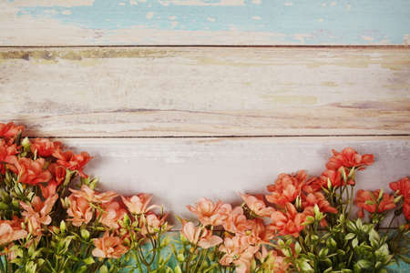 Flower frame with space for copy on wooden backgroundの写真素材