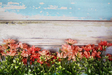 Flower frame with space for copy on wooden backgroundの写真素材