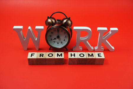 Work from Home alphabet letters with alarm clock on blue background