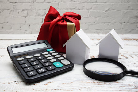 White Model House with magnifying glass and calculator on wooden background, realestate conceptの写真素材