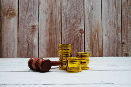 Golden coin and wooden judge gavel, Auction and bidding conceptの写真素材