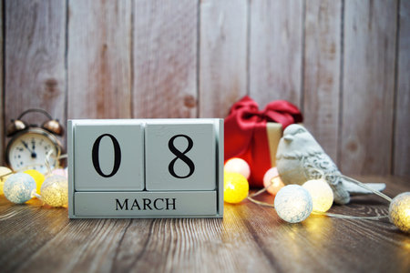 Wooden calendar March 08 on wooden background