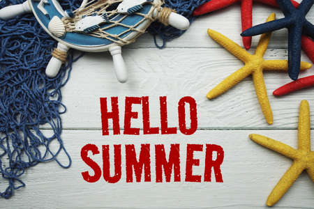 Hello Summe message decoration with nautical marine ornament on wooden backgroundの写真素材