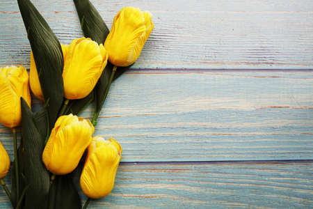 Yellow tulip flower bouquet with space copy on wooden backgroundの写真素材
