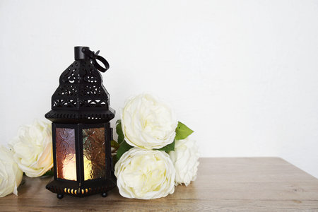 Ramadan Lantern Arabic decoration on wooden table and white wall background
