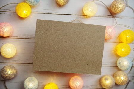 Empty Paper Caft with LED cotton balls on wooden background