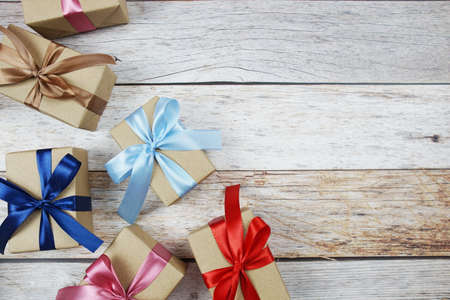 Gift boxes with ribbon on wooden backgroundの写真素材