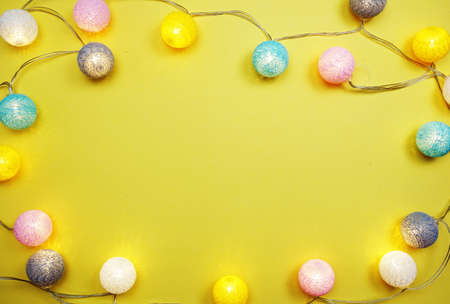 LED cotton ball garland decorate on yellow backgroundの写真素材
