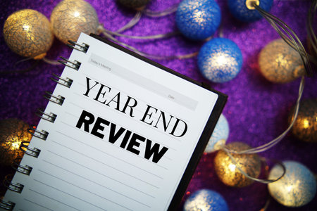 Year End Review text message on notepad background
