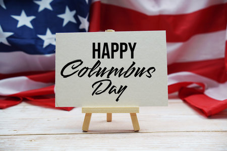 Happy Columbus Day text message  with USA flag on wooden background