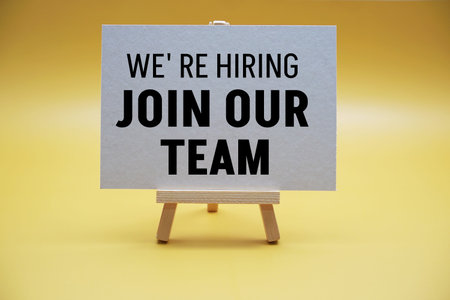 Join Our Team text message on yellow background