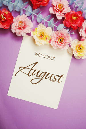 Welcome August typography text and flower decorate on purple backgroundの写真素材