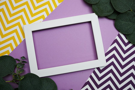 White Frame with Eucalyptus leaves on purple backgroundの写真素材