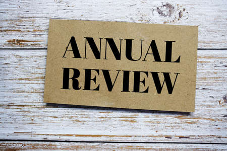Annual Review written on paper card top view of wooden backgroundの写真素材