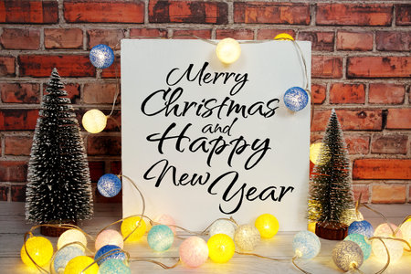 Merry Christmas and Happy New Year text message with LED cotton ball and pine tree