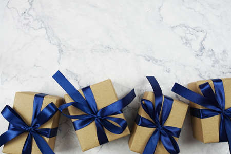 Gift boxes with blue ribbon on marble backgroundの写真素材