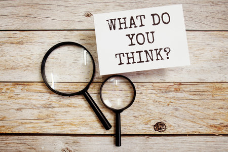 What do you think text message with magnifying glass on wooden backgroundの写真素材