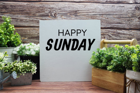 Happy Sunday text message on wooden backgroundの写真素材