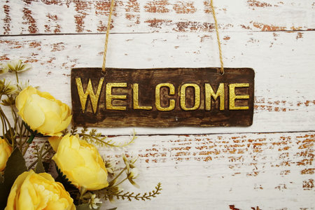 Welcome Sign with flowers frame decorate on wooden backgroundの写真素材