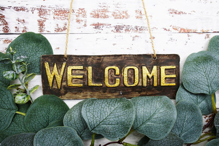 Welcome Sign with eucalyptus leaves frame decorate on wooden backgroundの写真素材
