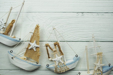 Nautical ornaments Antique sail boat Toy model on wooden background